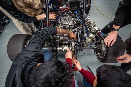 Students work on a competition vehicle in the SAE garage at Kettering University