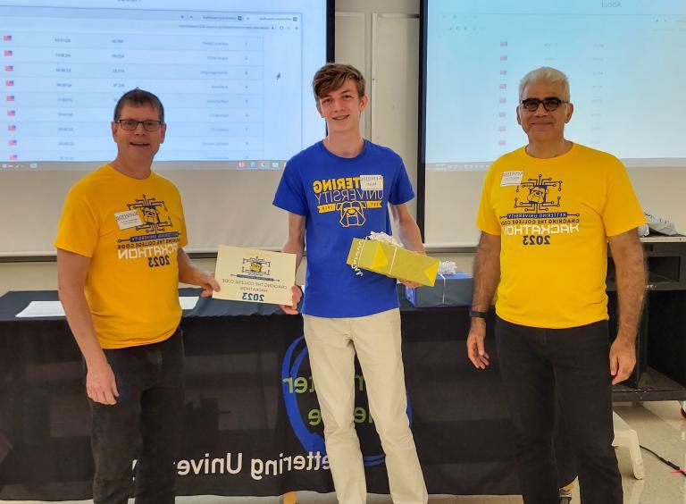 From left, Dr. Babak Elahi, Dean of the College of Sciences and Liberal Arts, Noah Gedraitis, second-place winner and Dr. Michael Farmer, Head of the Department of Computer Science at Kettering University.