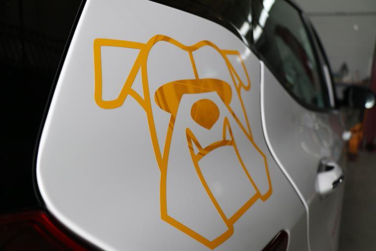 A side view of the Bulldog Bolt electric vehicle that has a yellow bulldog image on it.